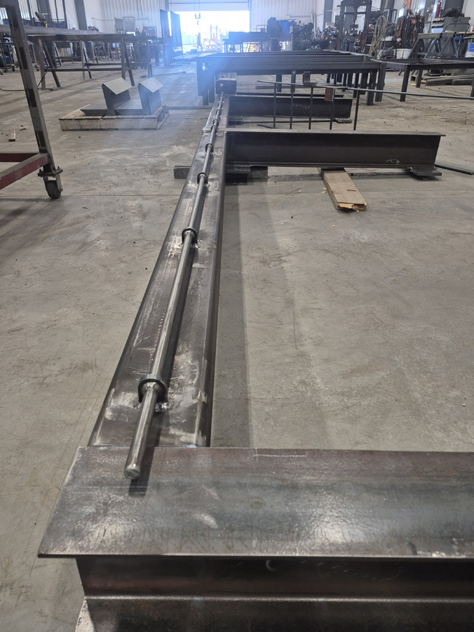 Image of structural steel I beams and other on the floor of the new Welding Shop Calgary.